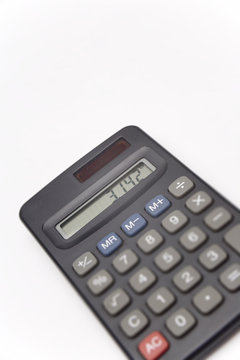 Calculator on white background showing value of pi, unsharp keyboard