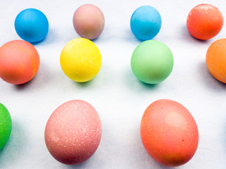 Color easter eggs on pastel blue background. Close up.