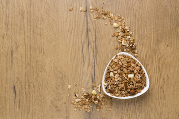 bowl of healthy granola on wooden background