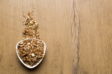 Obraz na płótnie Canvas bowl of healthy granola on wooden background