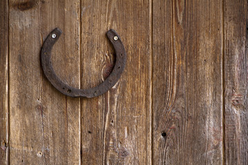 Old horses shoe nailed to a weathered wooden door