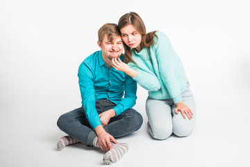 Portrait funny moments of excited couple fooling around to camera on white background. Having fun, weekends and valentines day concept