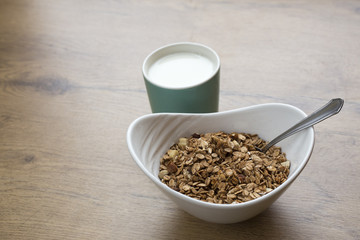 healthy breakfest on wooden table, oatmeal with milk