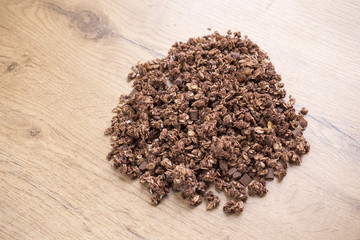 pile of chocolate healthy muesli on wooden table