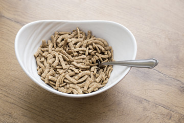 white bowl of healty cereals on wooden background