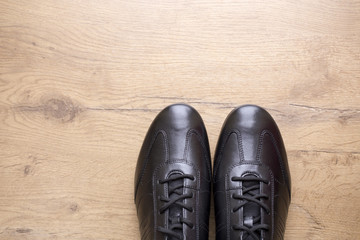 Black  leather men shoes on wooden background