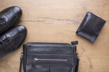 flat lay of black leather mens accessories
