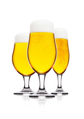 Cold glasses of lager beer with foam and dew
