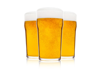 Cold glasses of lager beer with foam and dew