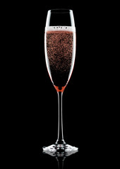 Rose pink champagne glass with bubbles on black
