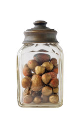 Old jar with nuts and hazelnuts on white background