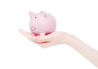 Female hand holds pink piggy bank