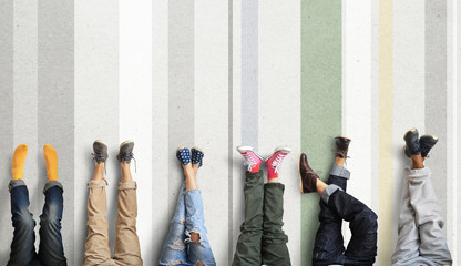 People's legs at the wall during a break in work