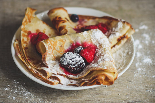 Pancakes with berries and sweet jam