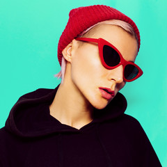 Blonde Model in fashionable sunglasses and beanie. Urban street style