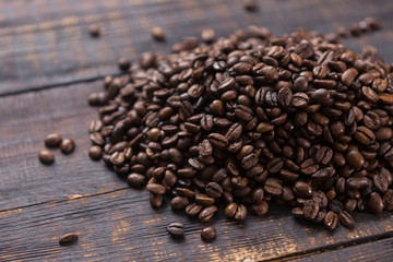 roasted coffee beans on dark wooden table