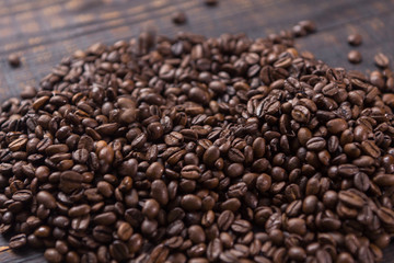 roasted coffee beans on dark wooden table