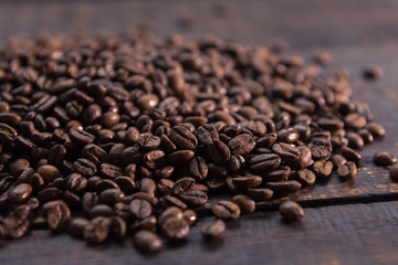 roasted coffee beans on dark wooden table