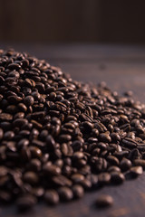 roasted coffee beans on dark wooden table