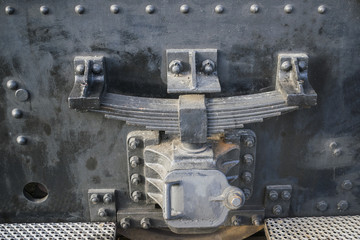 Industrial background with detail of old freight port locomotive frame and suspension system in historical harbor of Rotterdam, Netherlands.