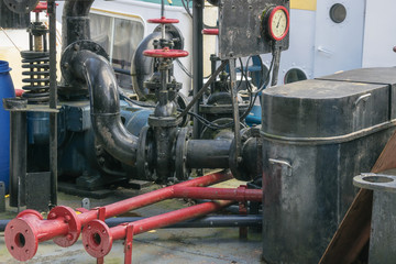 Industrial background with details of fuel oil pipes on deck of vintage ship in Rotterdam, Netherlands, illustrating old industrial technologies using natural resources.