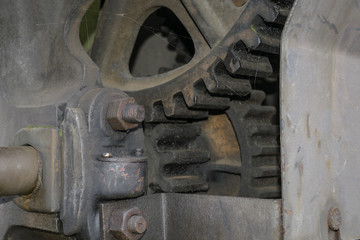 Industrial background with detail of old rusty gear wheels of seaport crane in Rotterdam, Netherlands.