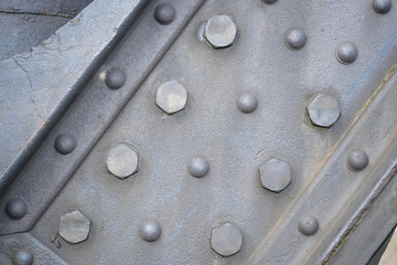 Detail of old sea port crane frame. Steel painted background with rivets illustrating industry and construction concepts.