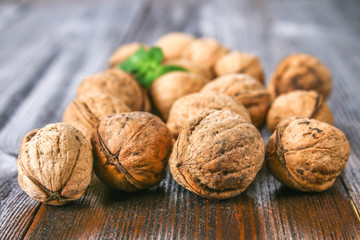 Shell and walnut bones on a brown wooden table.