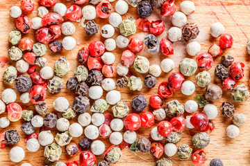 The pepper mix on a wooden background