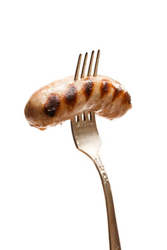 Grilled  Sausage On Vintage Fork Isolated On White