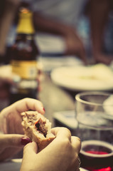 burger in woman's hands at outdoor barbecue party