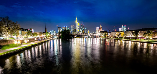 Frankfurt, Germany skyline at night beyond the river