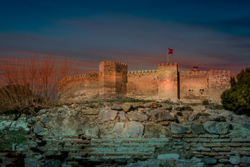 Naklejka premium Crusader castle flying a Turkish flag at sunset