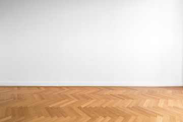wooden parquet floor and white wall background  