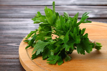 Fresh green parsley on the wooden table, selective focus.