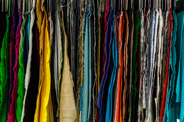 Closeup of colorful scarves hanging in the market.