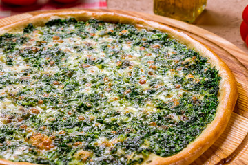 Pizza with spinach and nuts