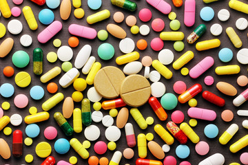 Colorful pills on grey background
