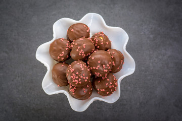 Valentine's Day concept, chocolate profiteroles with pink hearts, stuffed cakes,  special romantic event.