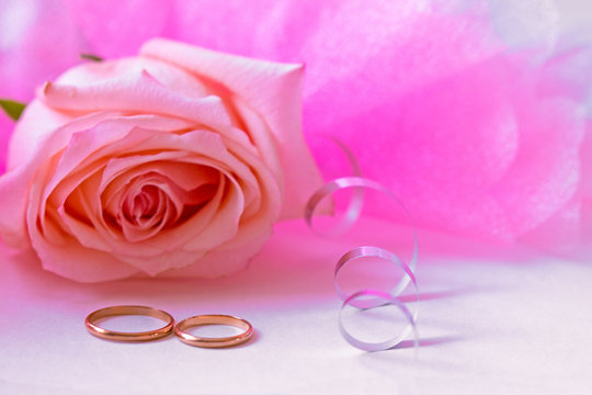 wedding card with rings and pink rose
