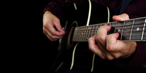 Playing an Acoustic Guitar. Closeup. Guitarist hands and guitar close up. Copy spaces.