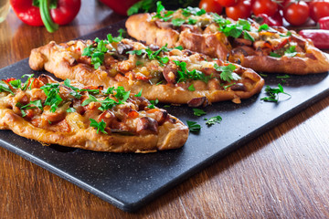 Traditional Turkish pide with meat and vegetables