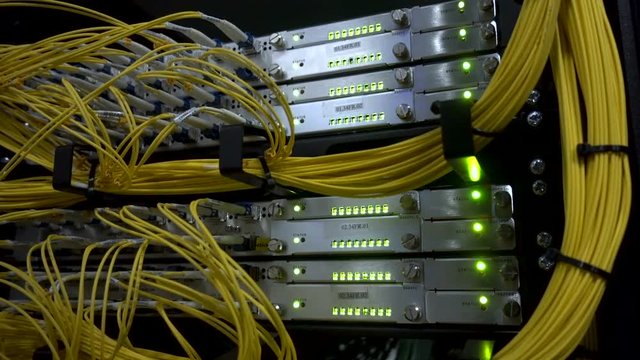 Optical server. Commutator. flashing lights. Optical fiber. Video IP Gateways. Audio. Severs computer in a rack at the large data center. Rack Mounted Servers. Close-up