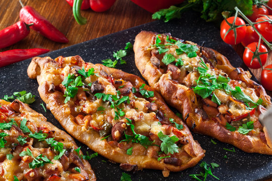Traditional Turkish pide with meat and vegetables