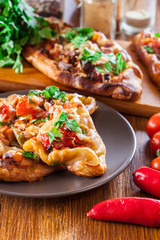 Sliced traditional Turkish pide with meat and vegetables