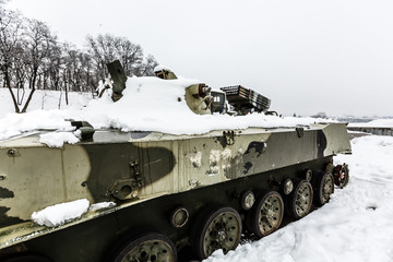 Armored personnel carrier military vehicle in the snow storm