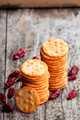 Round  shape rice cracker with chili pepper on wooden table