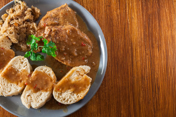 Pork loin in gravy with bread dumplings and sauerkraut