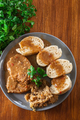 Pork loin in gravy with bread dumplings and sauerkraut
