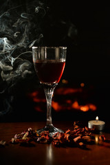 Romantic scene with smoke, wine Glass and Fireplace